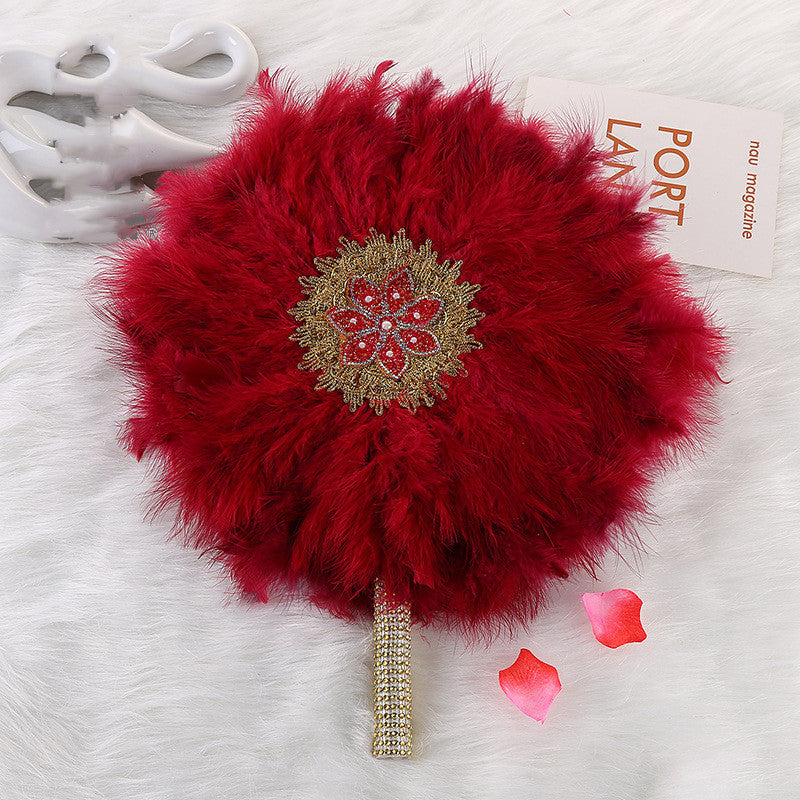 African Wedding Bride And Bridesmaid Holding A Big Round Feather Fan